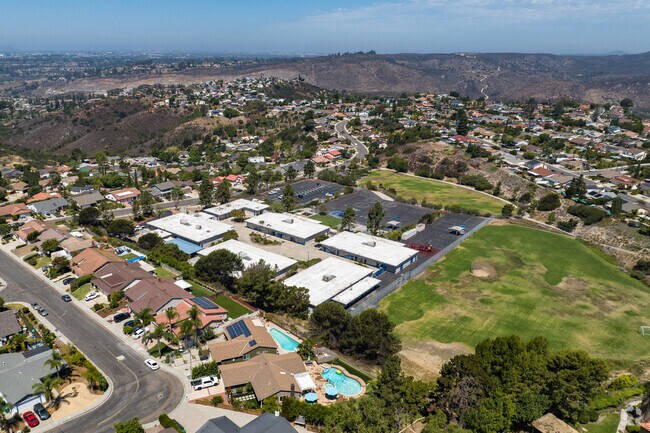 Zoom out aerial view of the entire building and the close neighborhood.