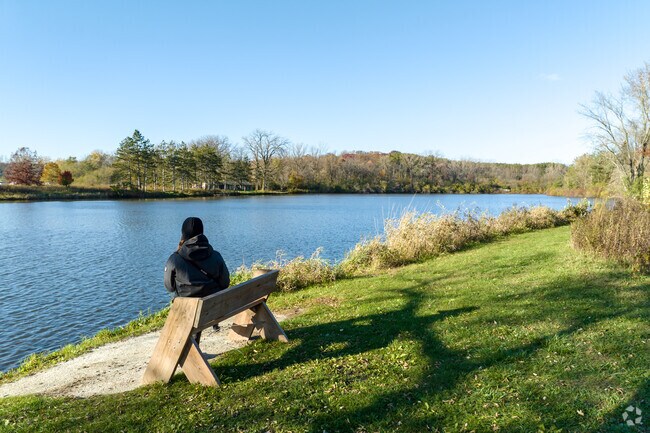 Walking paths along the lake at Brookdale Conservation Area have benches to take in the view.