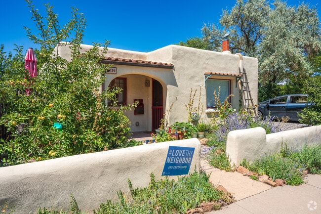 The Santa Fe architectural style is known for its flat roofs, rounded edges & stucco.