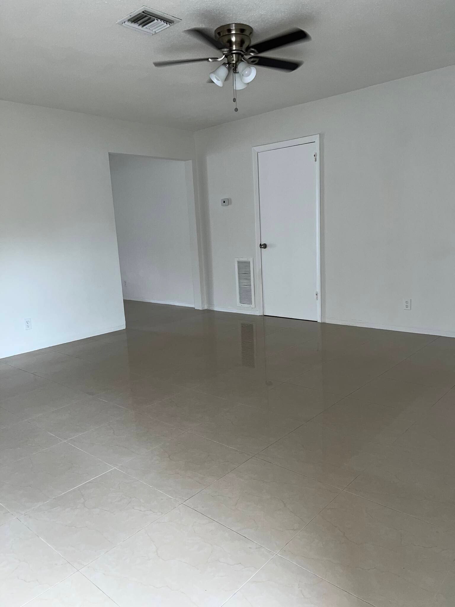 Living room: porcelain floors throughout. Ceiling fan in living room and two bedrooms
