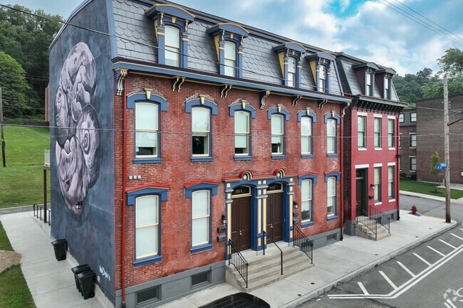 A row of Italianate-style town houses featuring tall windows in California-Kirkbride.