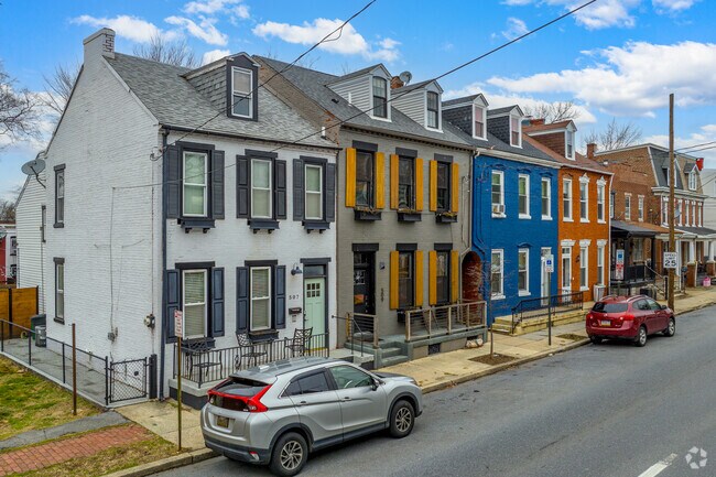 The colorful facades of the historic townhouses in East Side add character to the area.