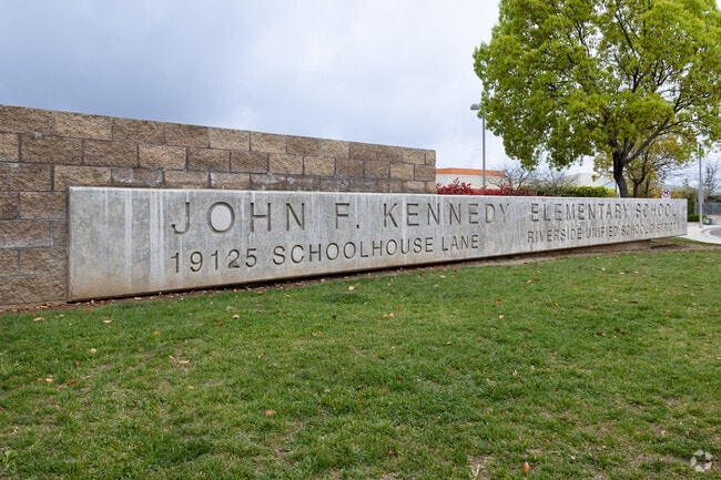 Concrete Sign on Green Lawn in Front of John F. Kennedy Elementary School.
