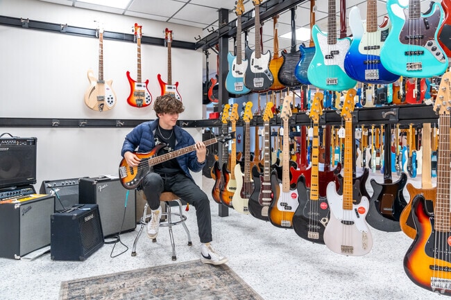 Dave's Guitar Shop near Old Village lets you play your favorite jam to find the perfect fit.