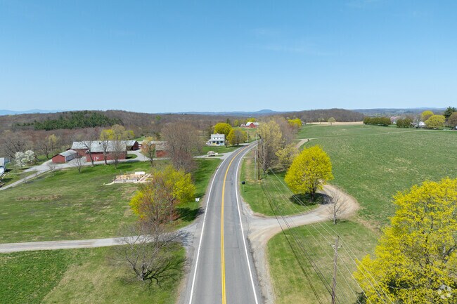 Driving through Washington offers scenic views of rolling hills and wooded roads.