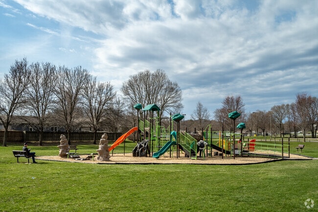 Families enjoy the playground at Deer Wood Park.