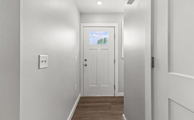 The entryway is bright and inviting, with a small mudroom/coatroom space.