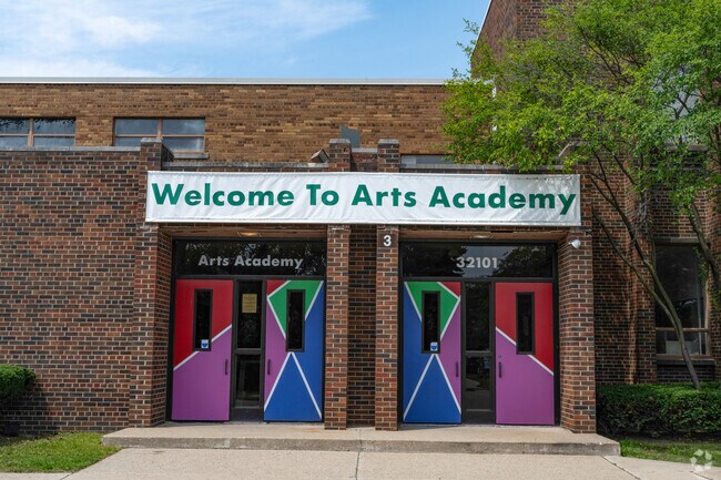 Arts Academy in the Woods has brightly painted doors welcoming students.