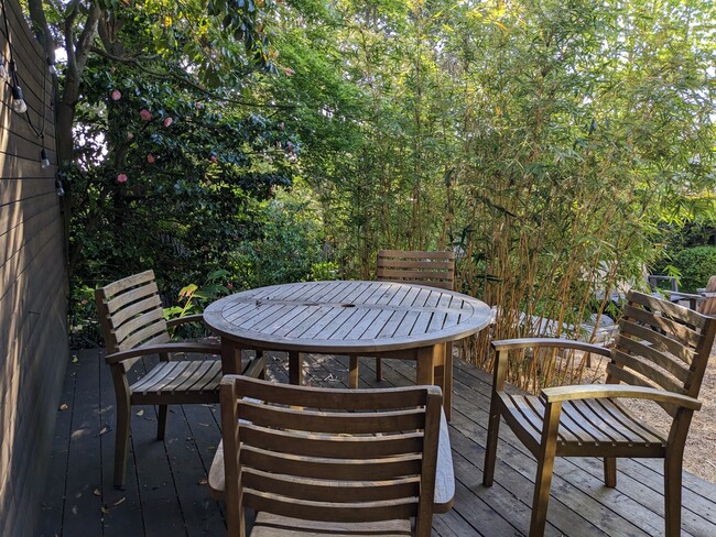 Private deck is surrounded by bamboo, camellias and a redwood tree.