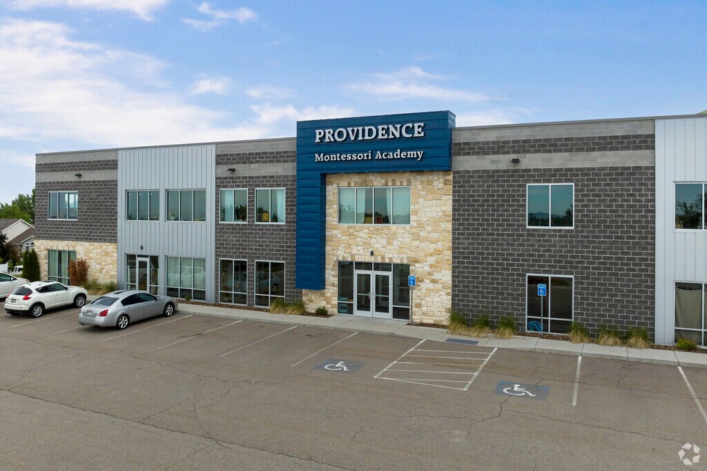 A blue detail stands out agains light stone work on Providence Montessori Academy’s facade in So