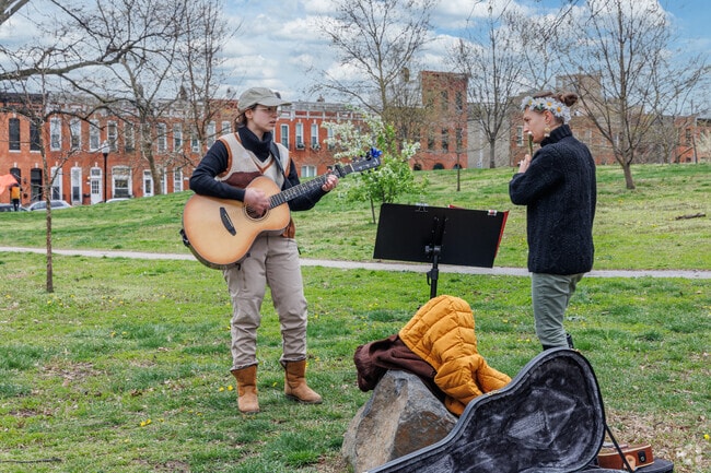 Musicians busk at Patterson Park, near Washington Hill, on a beautiful spring afternoon.