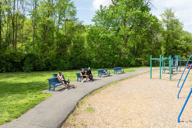 Residents relax in Johnny Appleseed Park, a green space in Maple-High Six Corners’ east end.