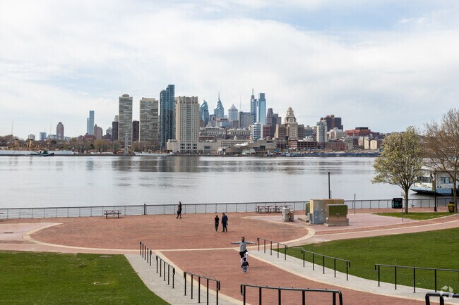 Visitors frequent Wiggins Waterfront Park for skyline views of Philadelphia across the river.