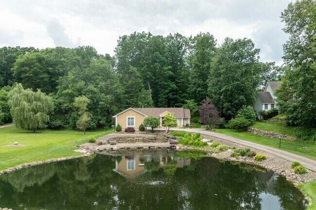 A well-maintained ranch-style home overlooks a tranquil pond in Brimfield.