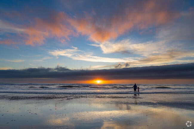 A family enjoys playing in the Pacific waters off Cannon Beach.