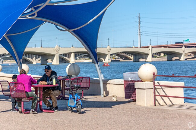 Apache neighborhood families hang out lakeside at Tempe Town Lake.