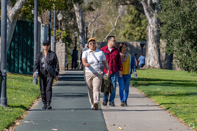 Alhambra Tract locals enjoy a walk through Almansor Park.