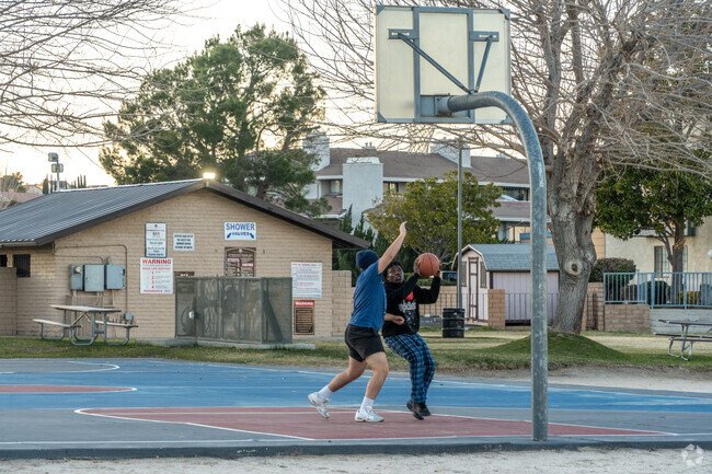 Residents enjoy healthy competition on the beach basketball court at Spring Valley Lake.