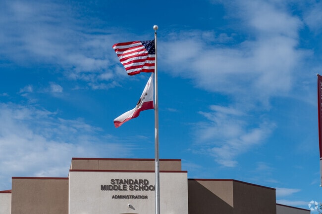 The flags fly high in front of Standard Middle School.