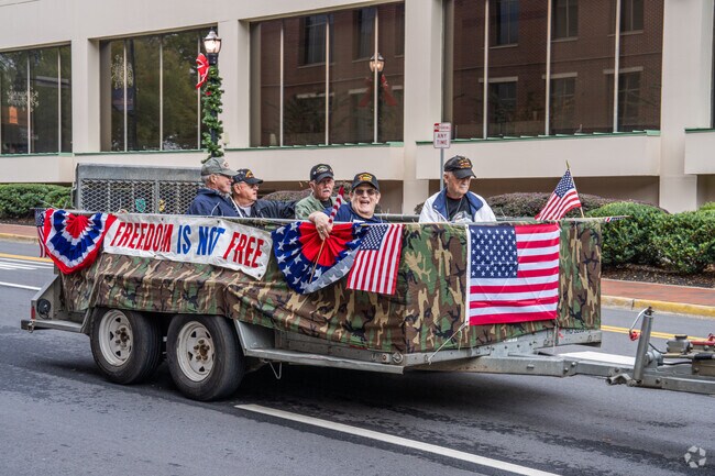Veterans ride in floats at the Veterans Day Parade.