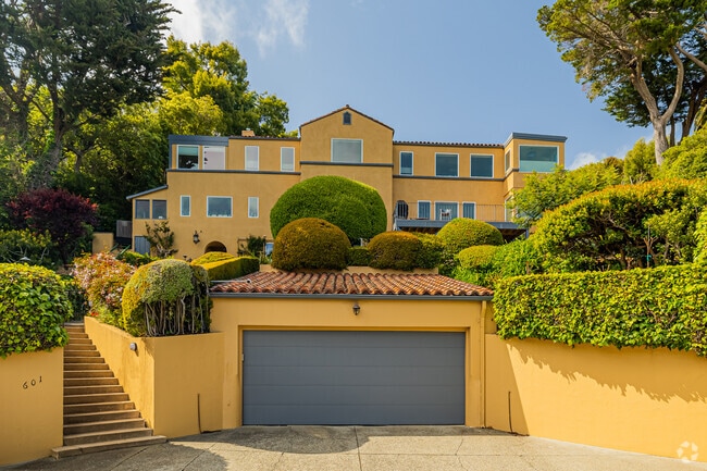 A large yellow Mediterranean-style home overlooks the streets of Sausalito.