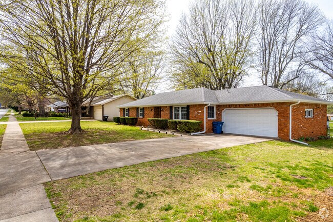 Homes sit beneath a canopy of mature trees throughout the Parkcrest neighborhood.