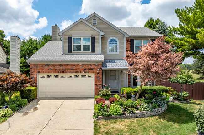 A contemporary two-story home in Brookhollow features a beautifully landscaped front yard.