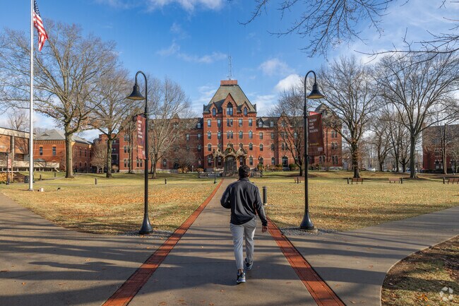 A student walks down the well manicured campus of Dean College in Downtown Franklin.