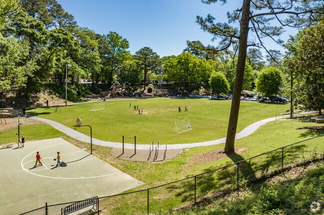 Children play in the field in front of Garden Hills Elementary School in the Garden Hills Neighborhood.