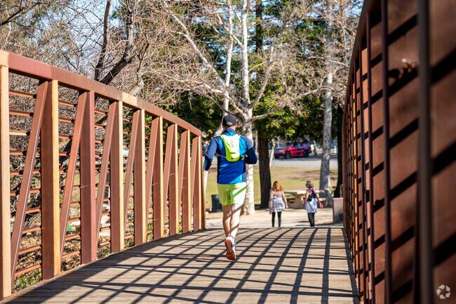Joggers run around Almaden Lake Park to enjoy its scenic lake views.