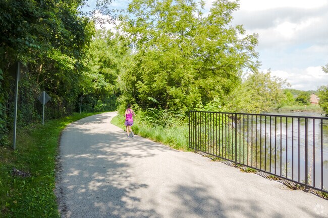 Locals enjoy the walking and biking path along the DuPage River in McDowell Forest Preserve.
