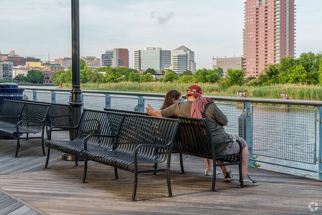 A couple takes time to relax at the promenade along the Christina River near Bayard Square.