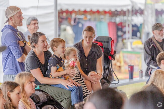 Kids are all smiles while watching Professor Smart during the Washington State Fair.