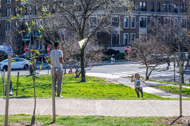 A girl leans forward to fly a kite at Kalorama Park on Columbia Rd NW.