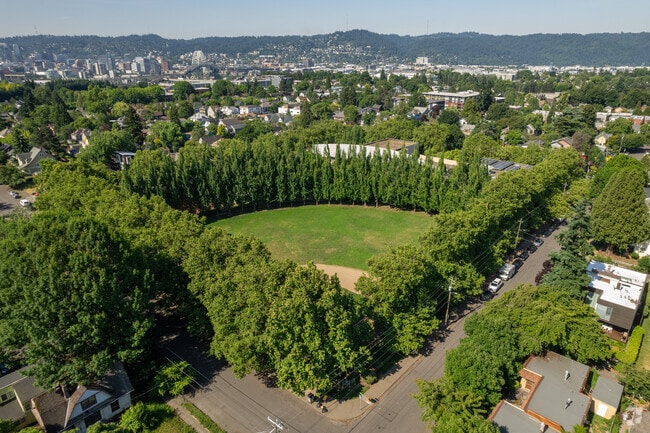 Above the tree lined baseball field of Unthank Park looking toward downtown Portland.