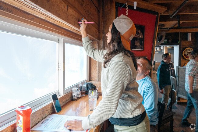 Guests sign their name on the famous wall at the Rogue Ales Brewery.