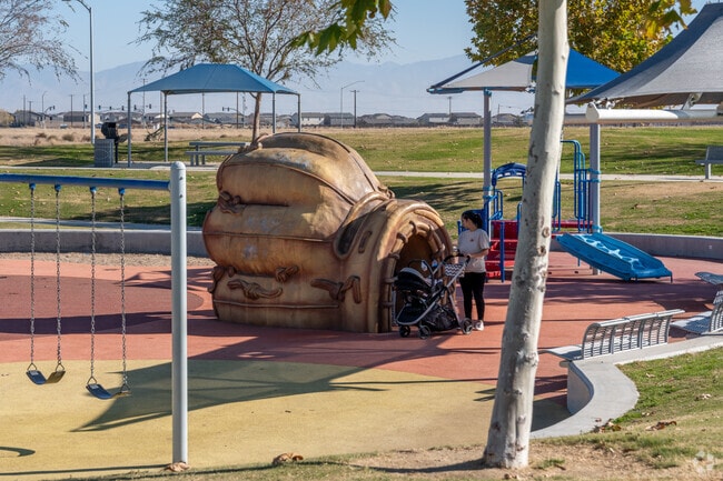 This family is playing in the glove at the playground at the Sports Village in Panama.
