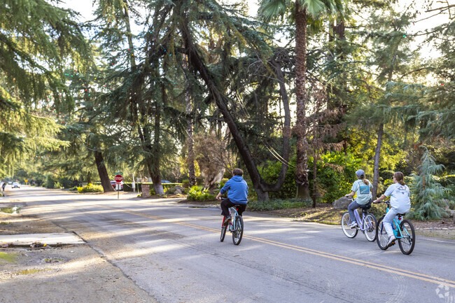 Residents of Fig Garden bike along tree-lined streets.