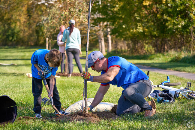 Friends and families plant a tree at the Trees for Charles Town event.