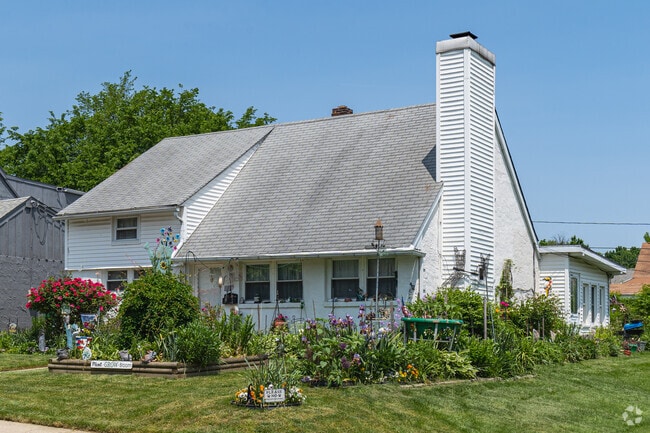 This well-manicured Cape Cod in Elsmere has abundant greenery.