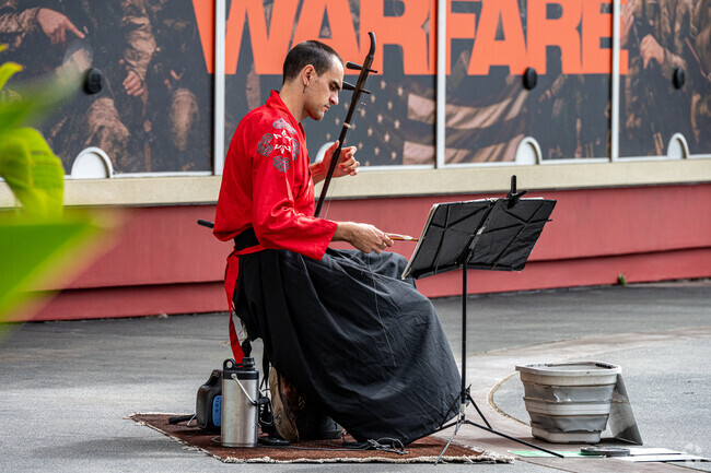 Visitors enjoy a street performance at the Atlantic Times Square in the Midwick Tract neighborhood of Alhambra.
