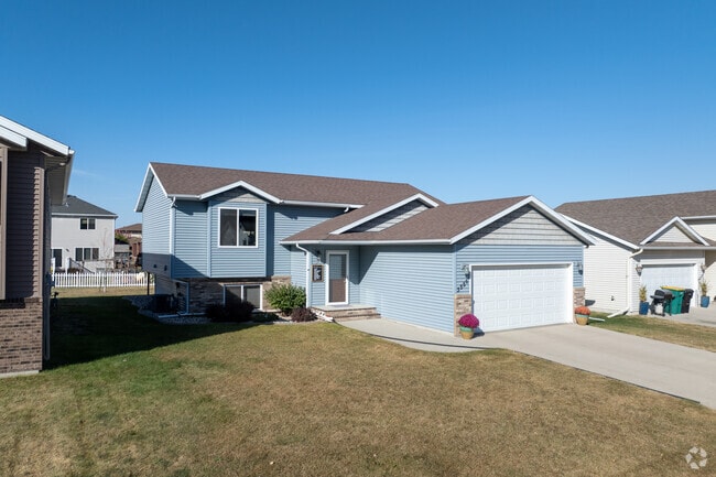 Homes in Shadow Wood-Shadow Creek feature large lawns and driveways.