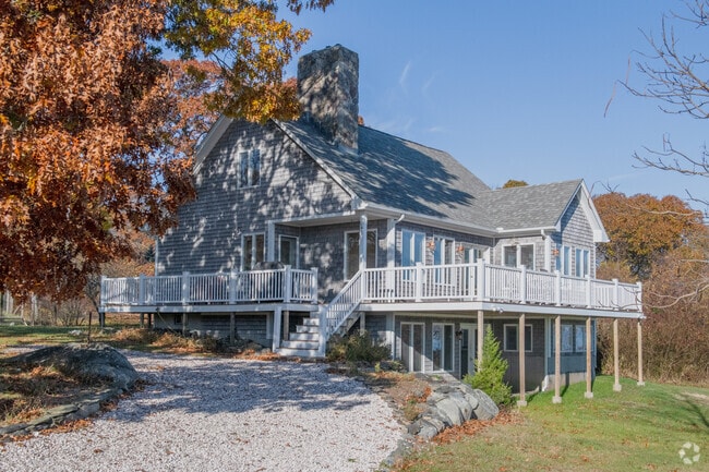 This generous home sits atop a hill and has a view of the sound by Prudence Island.