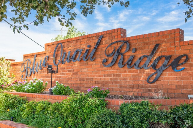The entry for Quail Springs greets you with a large brick sign.