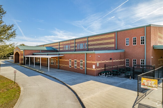 Kids walk through the entrance at Whispering Oak Elementary in Orange County.
