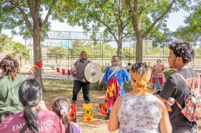 Locals in Sullivan Village enjoy the International Festival’s medieval performances.