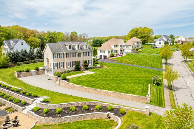 A row of beautiful, newly built homes on large grass lots in the Bradford Greens neighborhood of Haverhill, MA.