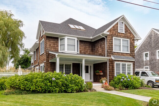 This wood-shingled home in the Lily-Almy Pond neighborhood exudes charm and distinction.