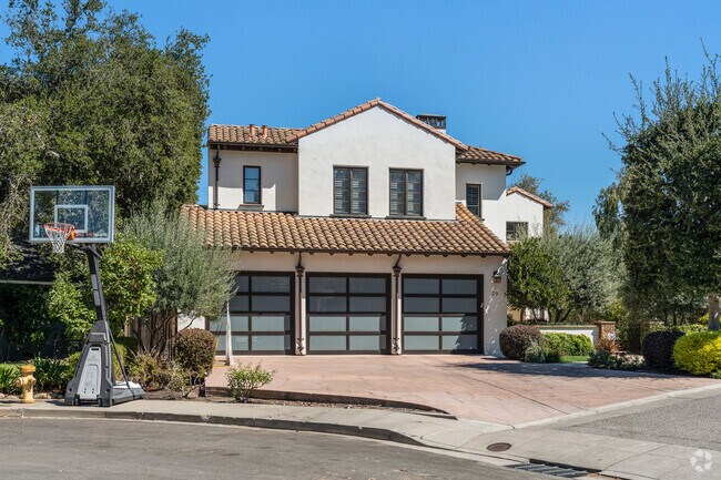 This Mediterranean-style home in Stanford Hills showcases a tiled roof and three-car garage.