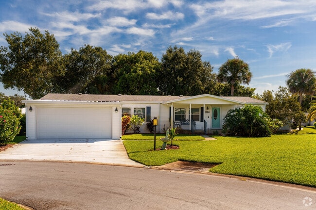 This Edgewater Landing home's backyard boasts mature trees, providing privacy and shade.